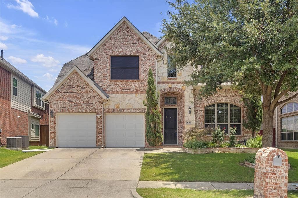 8730 Isaac Street, Plano, TX 75024 View of front of house featuring concrete driveway, brick siding, a front lawn, a garage, and a shingled roof
