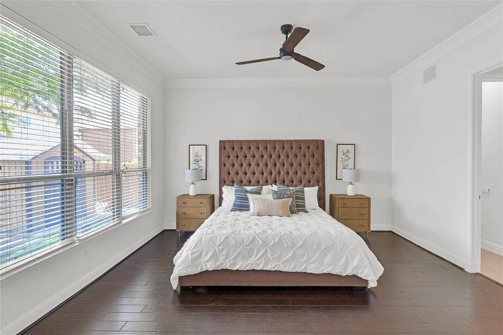 8730 Isaac Street, Plano, TX 75024 Bedroom with multiple windows, crown molding, dark wood-type flooring, and ceiling fan