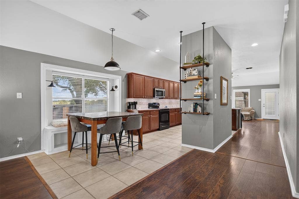 4001 Bridge Water Road, Heartland, TX 75126 Living space opens to dining area and kitchn