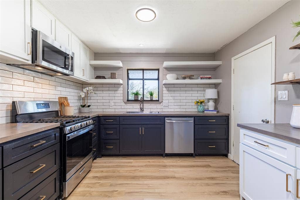 Kitchen with white subway tile backsplash and stainless steel appliances.