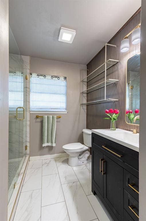 Renovated full bath with black modern cabinetry with golf finishes.