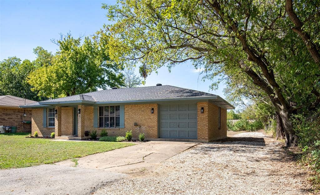 Situated on a corner lot, exterior features front entry garage and added gravel driveway.
