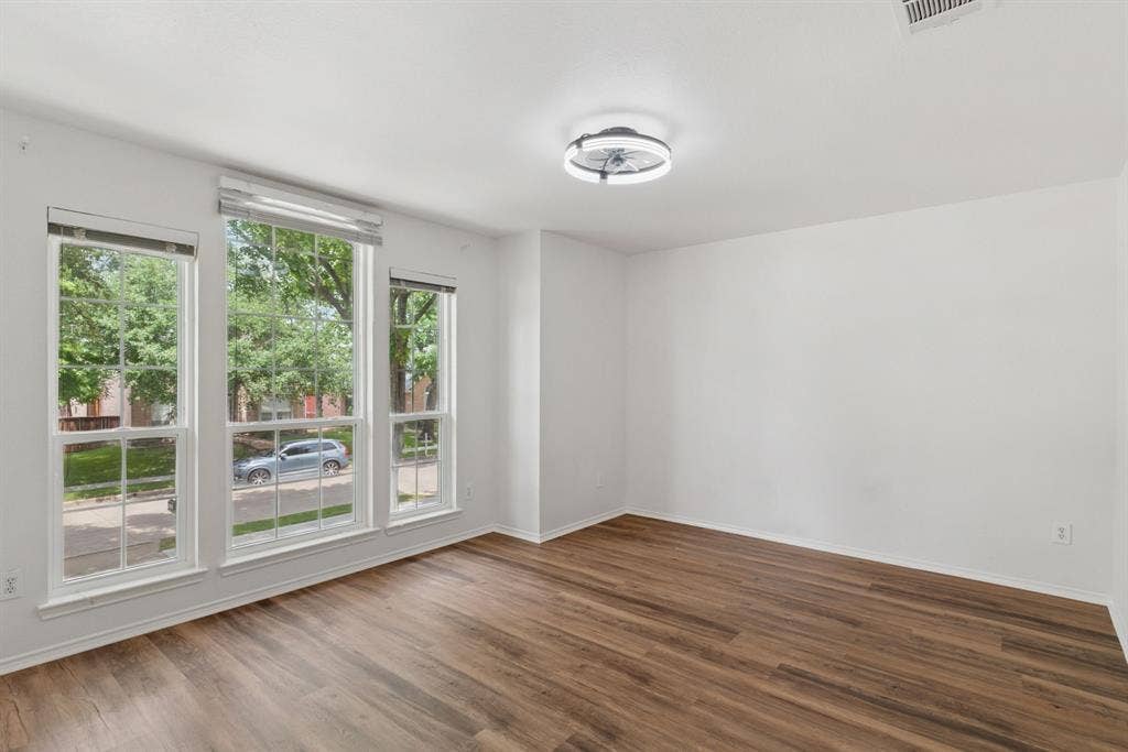 4816 Rockcreek Lane, Plano, TX 75024 Wood-finish flooring throughout, multiple windows, and a flush mount lighting fixture