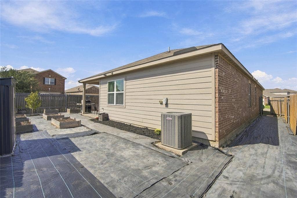101 Rebel Ridge, Venus, TX 76084 Exterior featuring horizontal siding, brick masonry, a covered patio, and raised planting beds