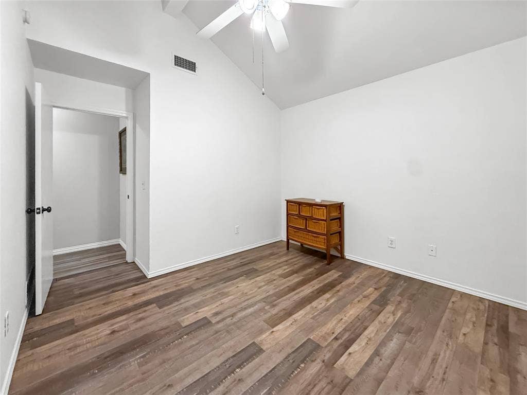 316 N Winding Oaks Drive, Wylie, TX 75098 Vaulted ceiling with a white ceiling fan, wood-finish flooring, and white walls