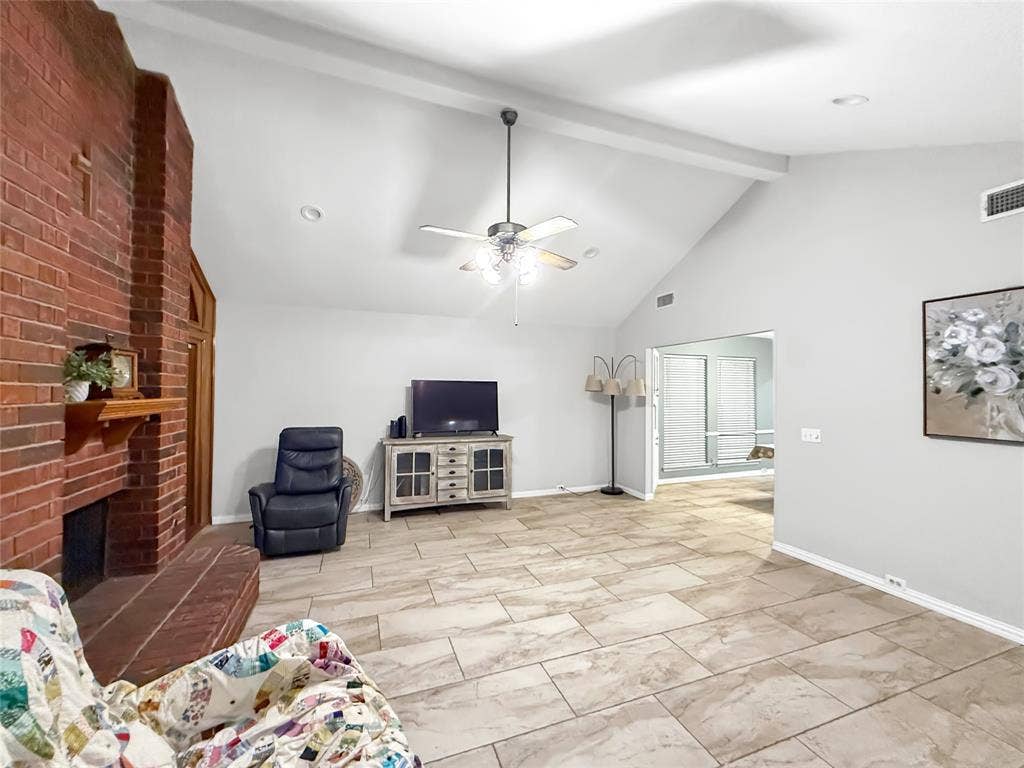 316 N Winding Oaks Drive, Wylie, TX 75098 Vaulted ceiling, brick fireplace with mantel, recessed lighting, ceiling fan, and large format tile flooring