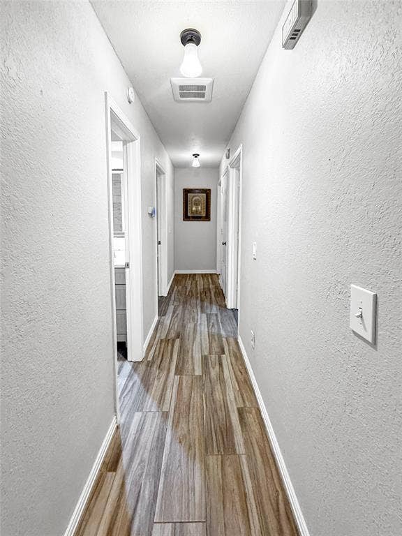 316 N Winding Oaks Drive, Wylie, TX 75098 Long hallway featuring wood-finish tile flooring, recessed lighting, and crisp white trim
