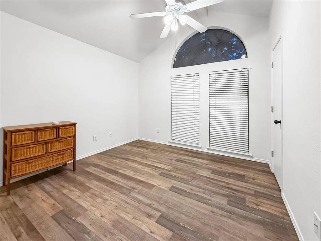 316 N Winding Oaks Drive, Wylie, TX 75098 Vaulted ceiling with a white ceiling fan, wood-finish flooring, and white walls