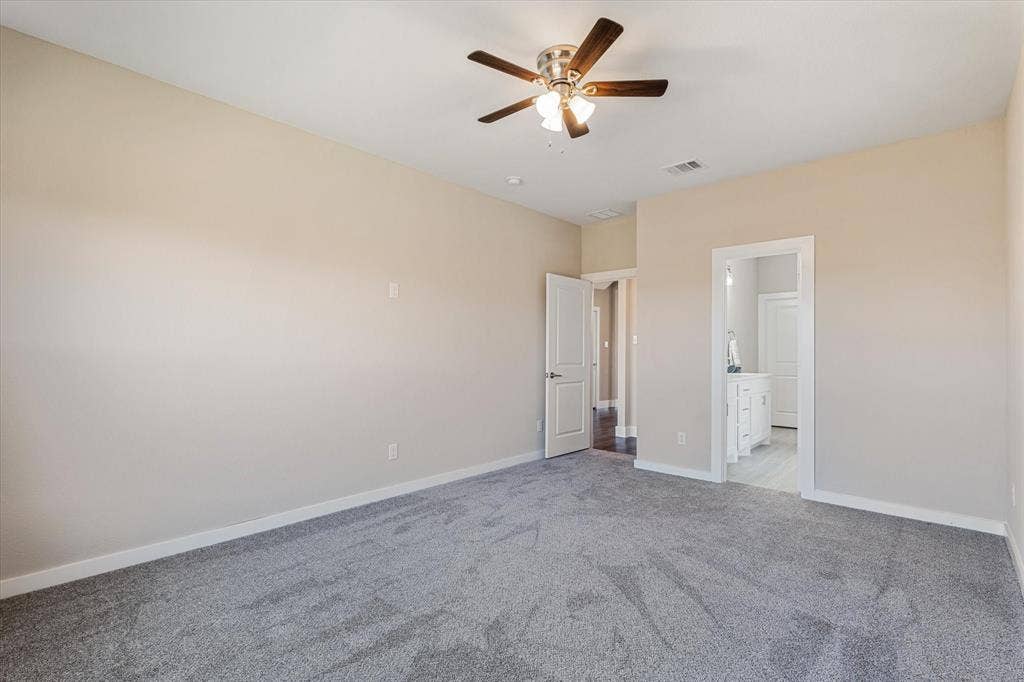 Neutral paint, ceiling fan, and grey carpet flooring