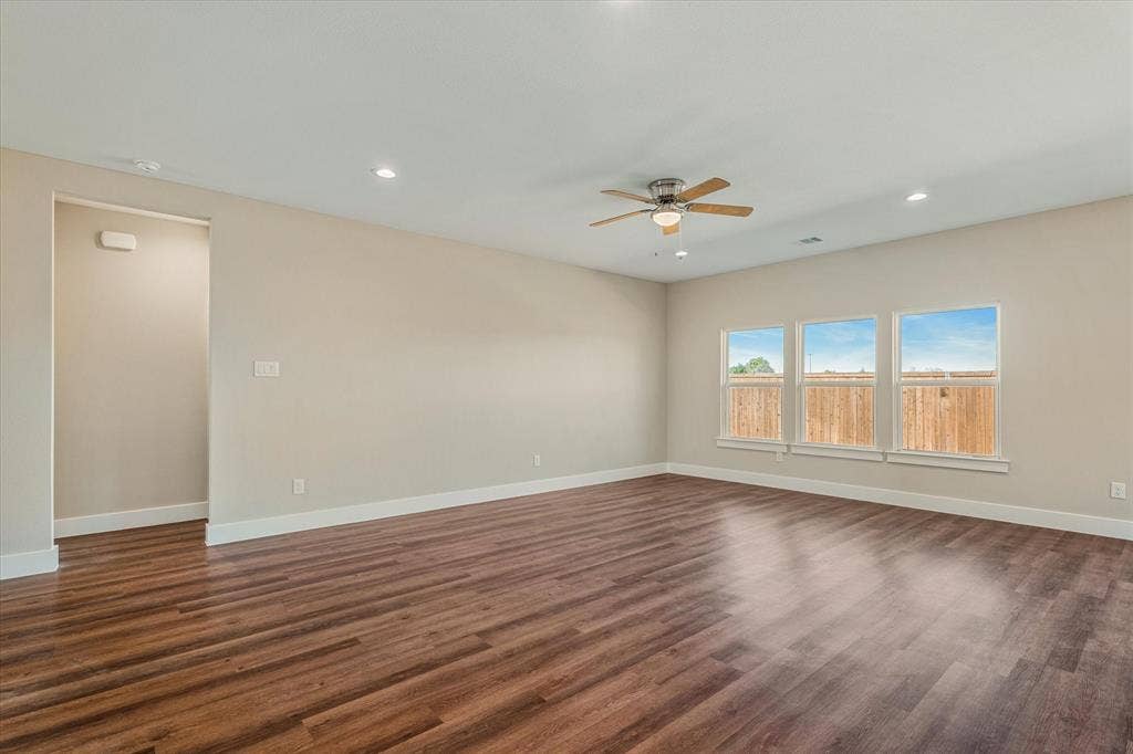 Wood-finish flooring, recessed lighting, and a ceiling fan with light fixture