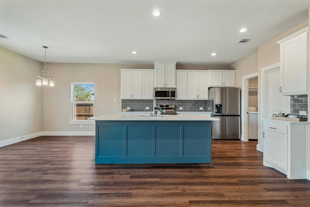 Open-concept living space with wood-finish flooring