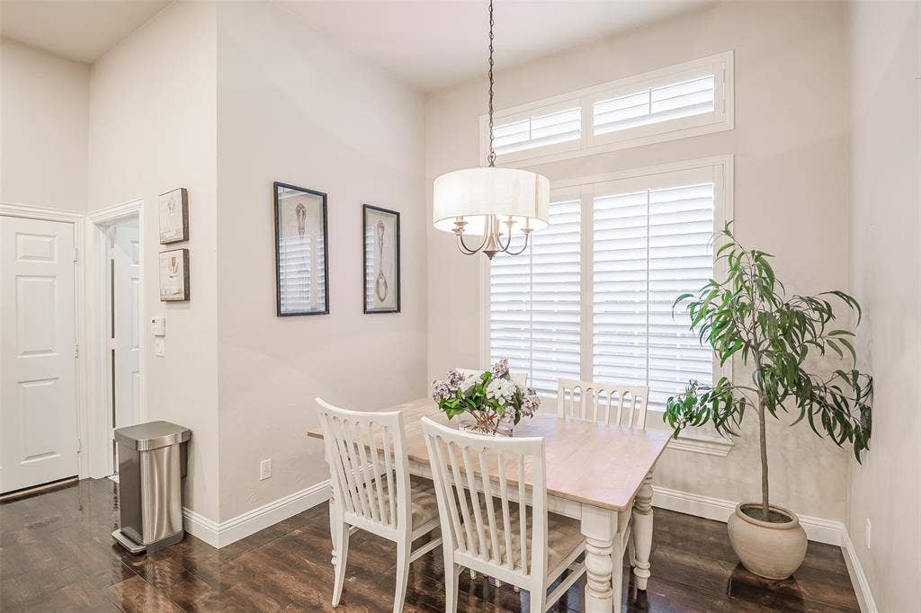 5925 Westmont Drive, Plano, TX 75093 High ceilings with crown molding, wood-finish flooring, plantation shutters, and a drum-shade chandelier