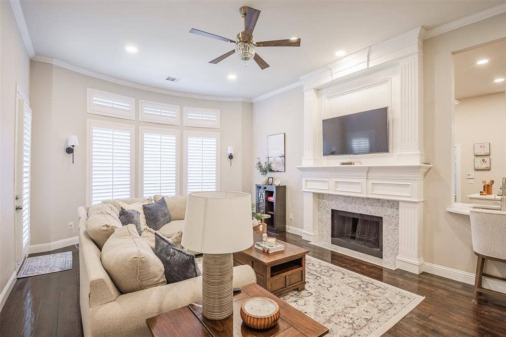 5925 Westmont Drive, Plano, TX 75093 Living area featuring dark wood-finish flooring, a white mantel fireplace with a tile surround, recessed lighting, and a ceiling fan