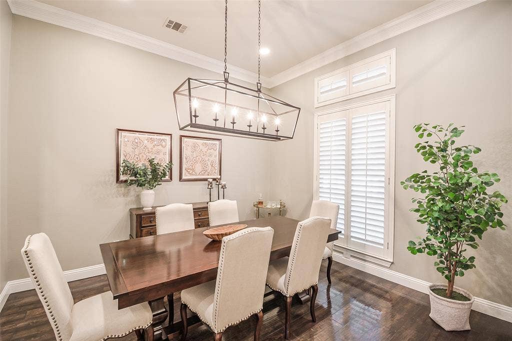 5925 Westmont Drive, Plano, TX 75093 Crown molding, wood-finish flooring, recessed lighting, plantation shutters, and a linear chandelier