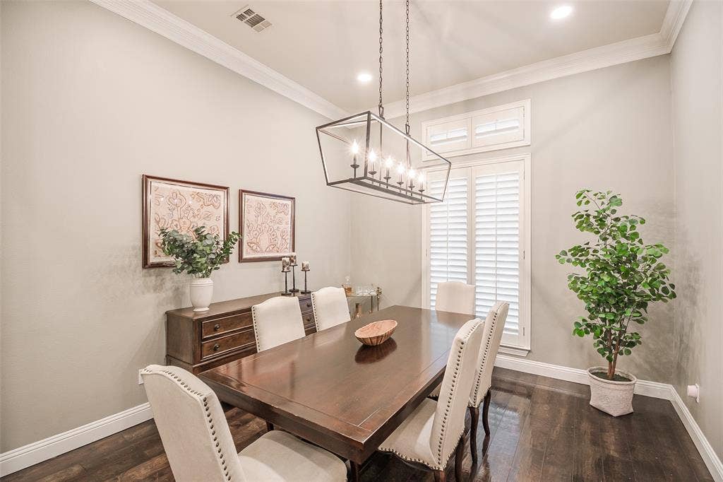 5925 Westmont Drive, Plano, TX 75093 Recessed lighting, crown molding, wood-finish flooring, plantation shutters, and a linear chandelier