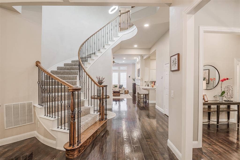 5925 Westmont Drive, Plano, TX 75093 Hardwood flooring, curved staircase with wrought iron balusters, recessed lighting, and crown molding