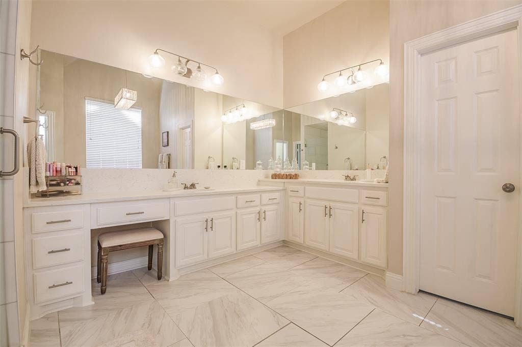 5925 Westmont Drive, Plano, TX 75093 Dual vanity with white cabinetry, quartz-finish countertop, and integrated sinks