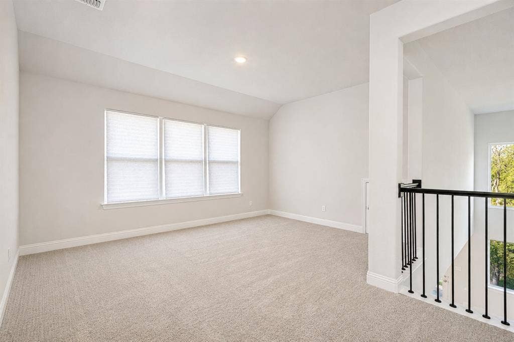 2902 Cremini Fls, Princeton, TX 75407 Wall-to-wall carpeting and neutral wall tones define this expansive room, complemented by a recessed light fixture