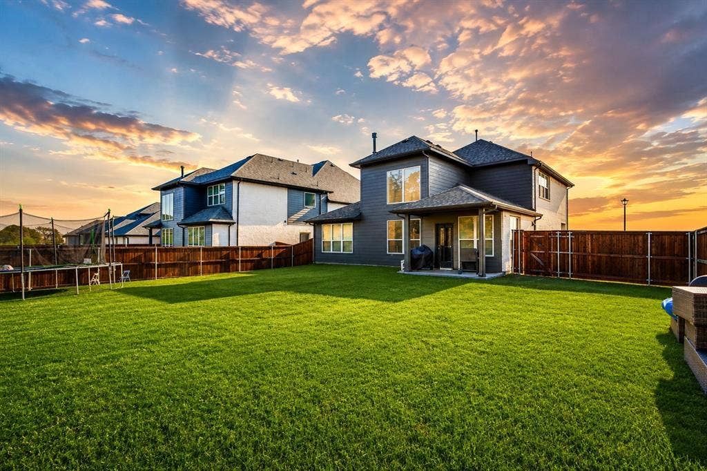 2902 Cremini Fls, Princeton, TX 75407 Expansive green lawn with a privacy fence