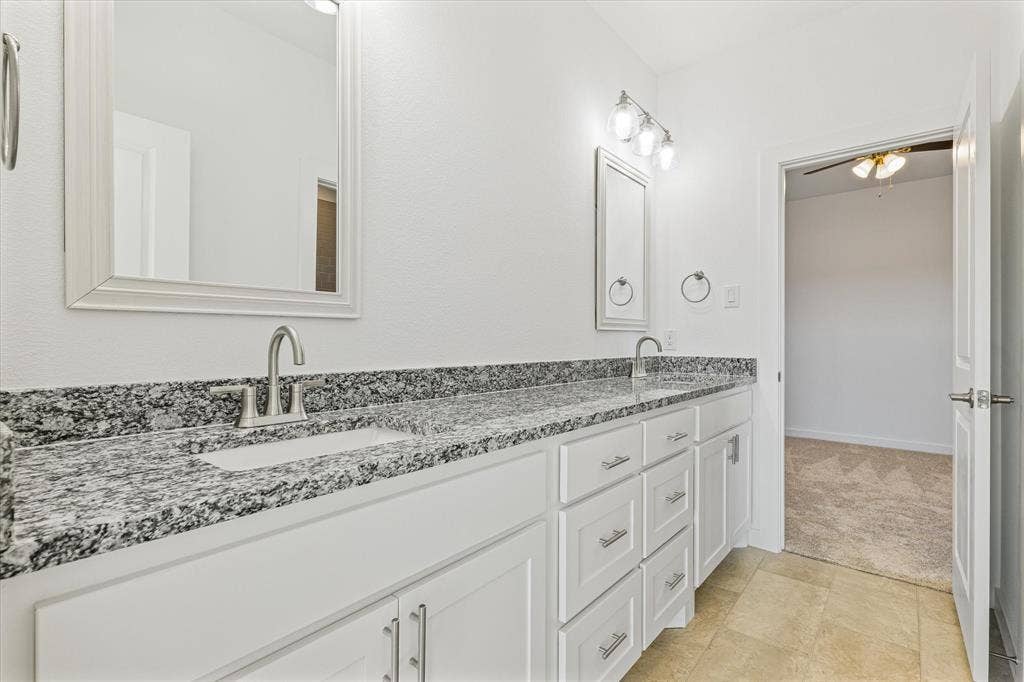 Dual vanity with granite countertops, undermount sinks, and brushed nickel fixtures