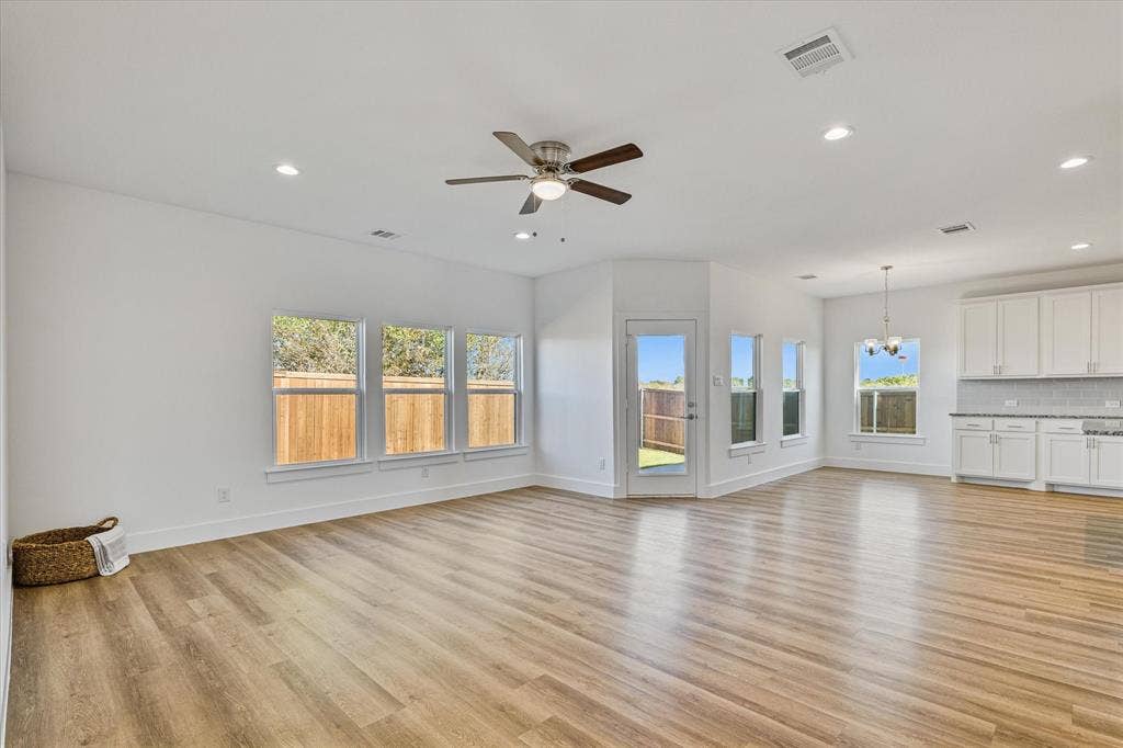 Open-concept common area featuring wood-finish flooring, white walls, and recessed lighting