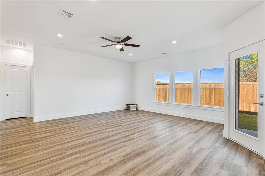 Wood-finish flooring, recessed lighting, and a ceiling fan