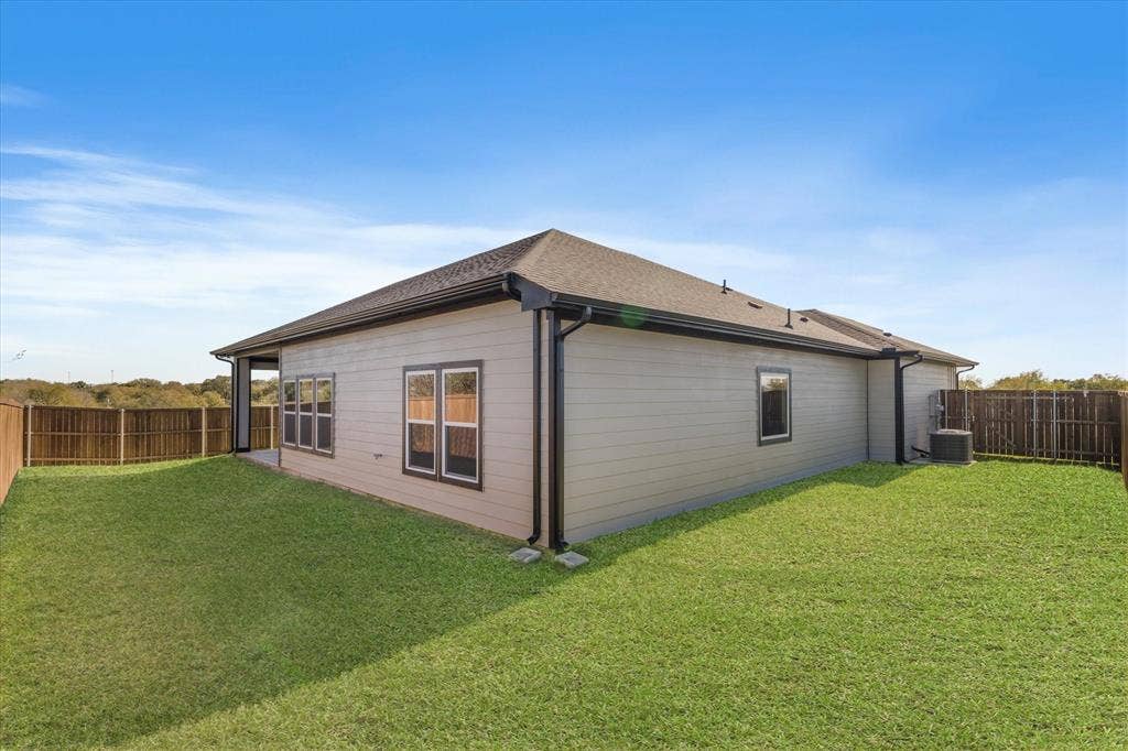 Spacious grassy yard with wood fencing