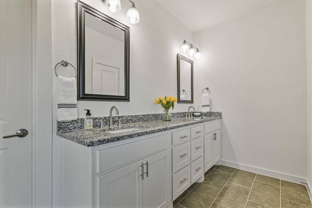 Dual vanity with white cabinetry and brushed nickel hardware