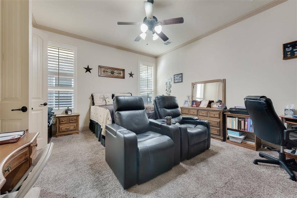 5056 Empire Way, Irving, TX 75038 Downstairs Primary Bedroom featuring ceiling fan and ornamental molding