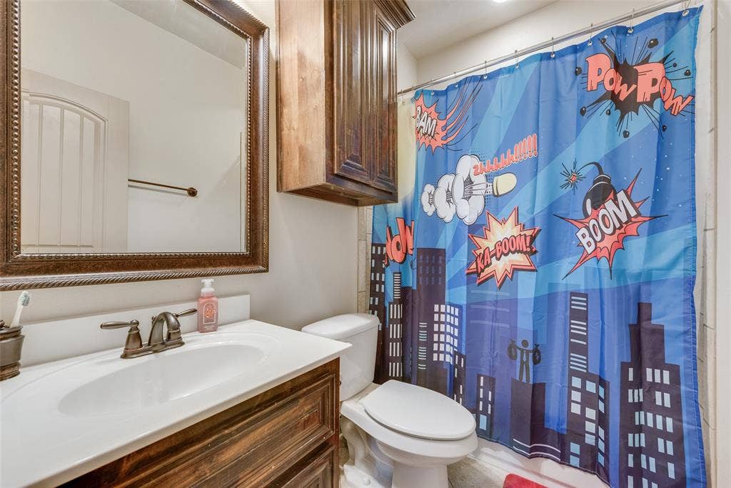 5056 Empire Way, Irving, TX 75038 Bathroom #6 featuring walk in shower, vanity, and toilet