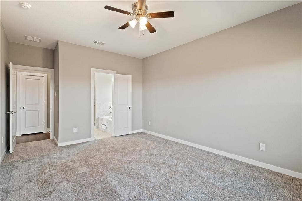 Gray wall paint and light gray carpet, with a ceiling fan