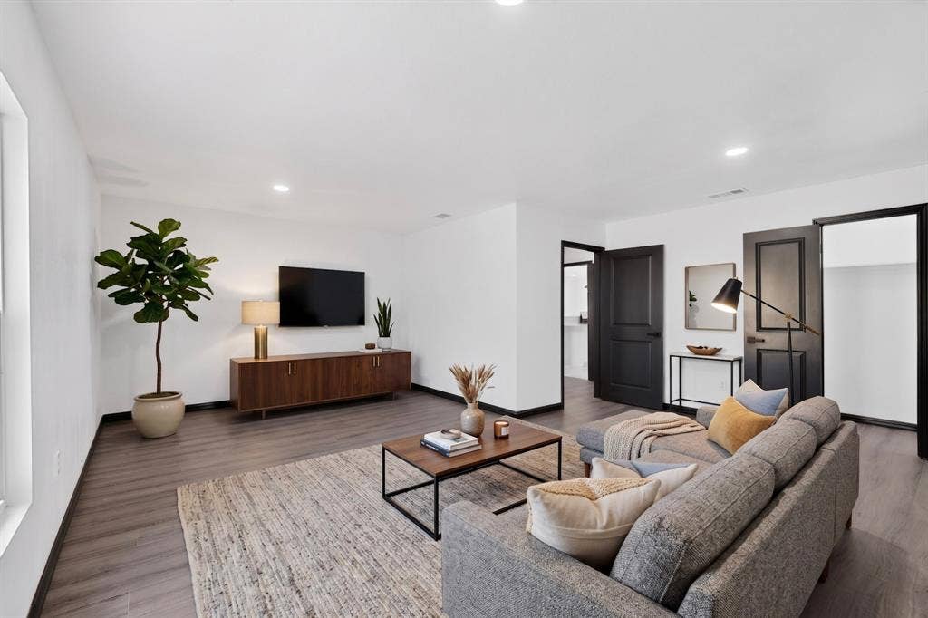 301 Stoneport Drive, Dallas, TX 75217 Recessed ceiling lighting, wood-finish flooring, white walls, and dark interior doors