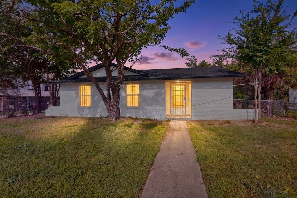 301 Stoneport Drive, Dallas, TX 75217 Single-story residence with a dark roof and light-colored siding