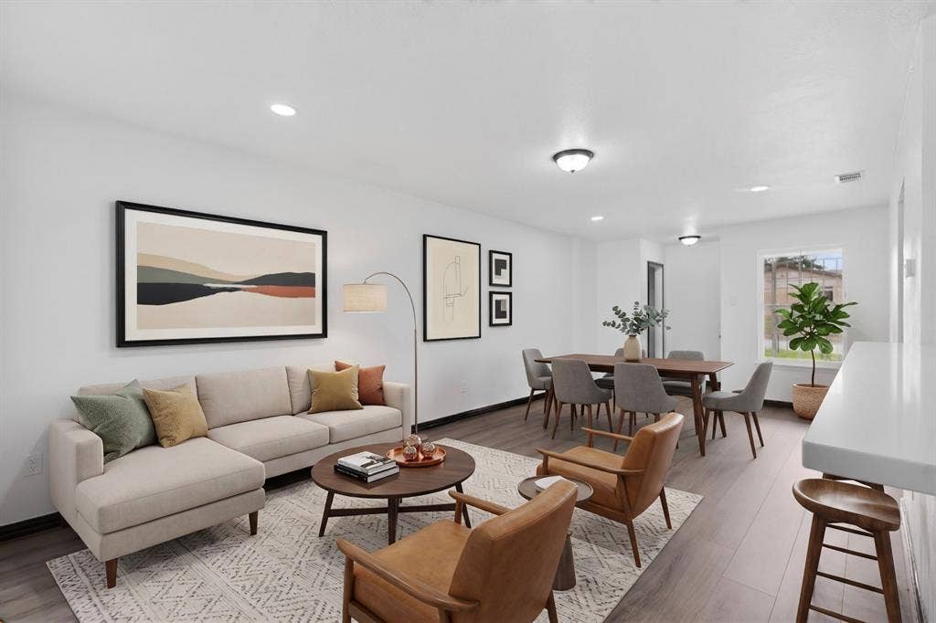 301 Stoneport Drive, Dallas, TX 75217 Open-concept living area featuring wood-finish flooring, recessed lighting, and a dining space with a ceiling-mounted light fixture