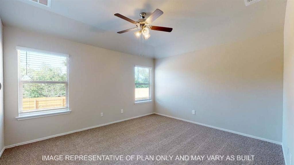 10412 Altair Drive, Waco, TX 76708 Carpeted flooring, vaulted ceiling, two windows, and a ceiling fan with integrated lighting