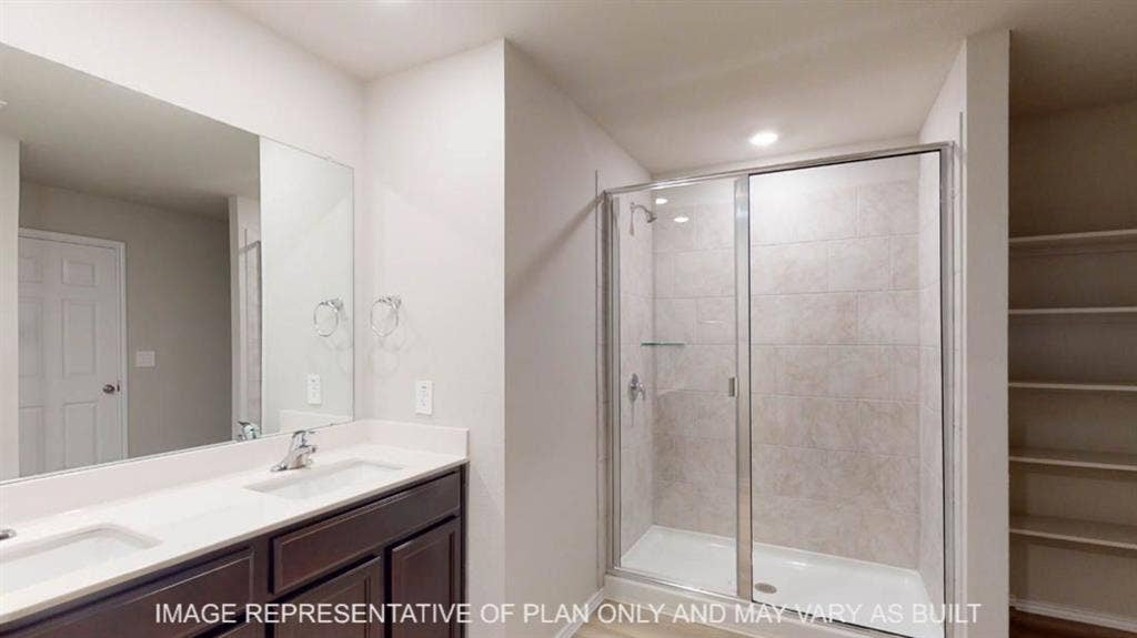 10405 Altair Drive, Waco, TX 76708 Double vanity with undermount sinks and dark wood cabinetry