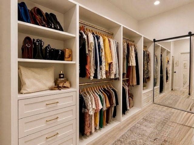 107 Appalachian Way, McKinney, TX 75071 Custom built-in closet system featuring multiple shelving units, integrated drawers with gold-finish hardware, and dual hanging rods