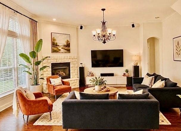 107 Appalachian Way, McKinney, TX 75071 Stone-clad fireplace, wood-finish flooring, recessed lighting, arched entryway, and a multi-arm chandelier