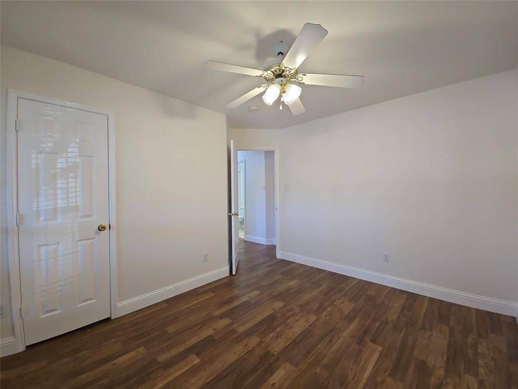 2424 Brycewood Lane, Plano, TX 75025 Wood-finish flooring, white walls, white trim, and a ceiling fan with integrated lighting