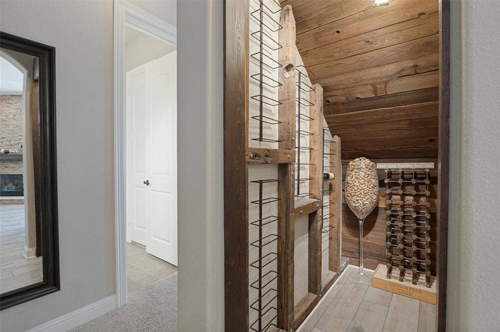 1504 Daisy Lane, Flower Mound, TX 75028 Custom wine storage with wood plank walls and wood-finish flooring