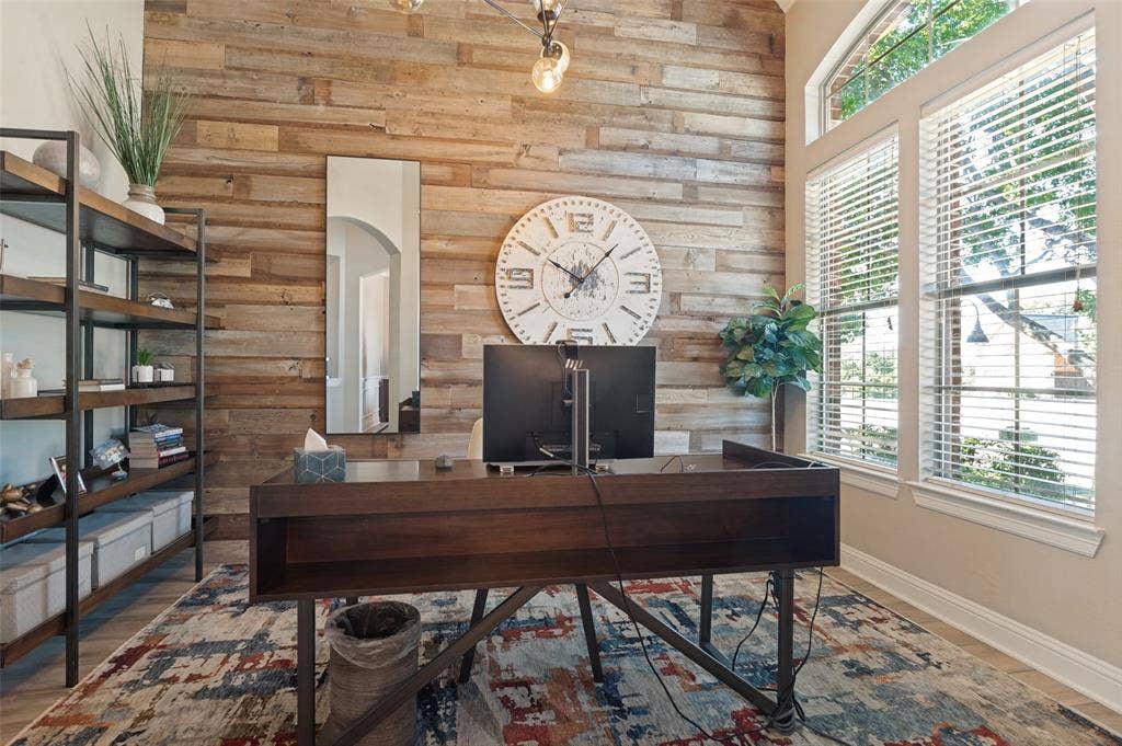 1504 Daisy Lane, Flower Mound, TX 75028 Wood-panel accent wall, vaulted ceiling, and multiple large windows with blinds