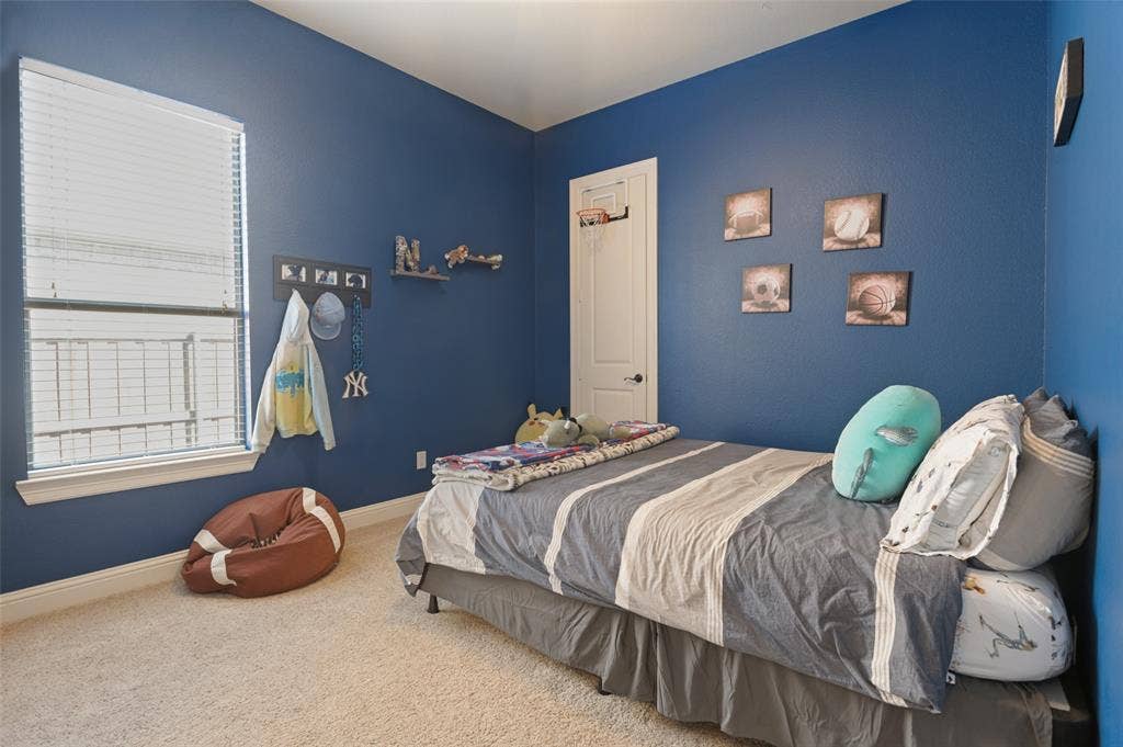 1504 Daisy Lane, Flower Mound, TX 75028 Carpeted room featuring a single window with blinds, white trim, and a built-in door