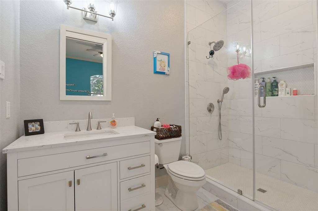 1504 Daisy Lane, Flower Mound, TX 75028 White vanity with brushed nickel hardware and a white countertop