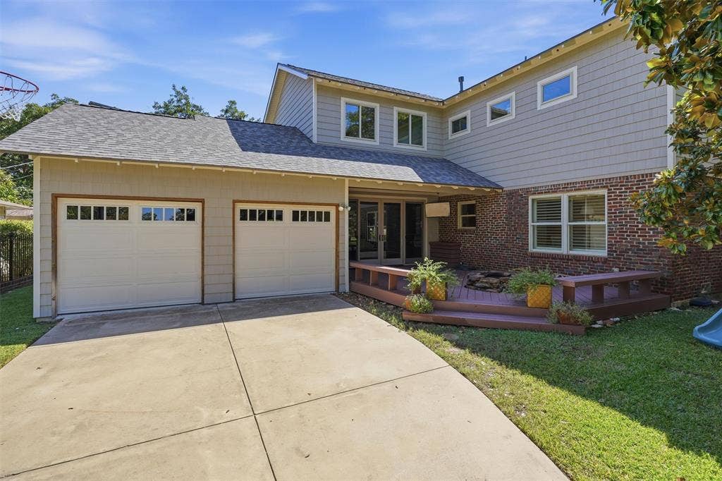 3712 Brighton Road, Fort Worth, TX 76109 Great view of the two car, double door garage. Large outdoor deck with firepit, perfect for family gatherings.