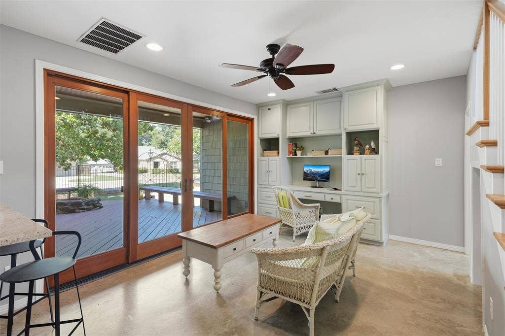 3712 Brighton Road, Fort Worth, TX 76109 Versatile sunroom or flex space featuring polished concrete floors and custom built-in desk, plus a bar opening back into the kitchen