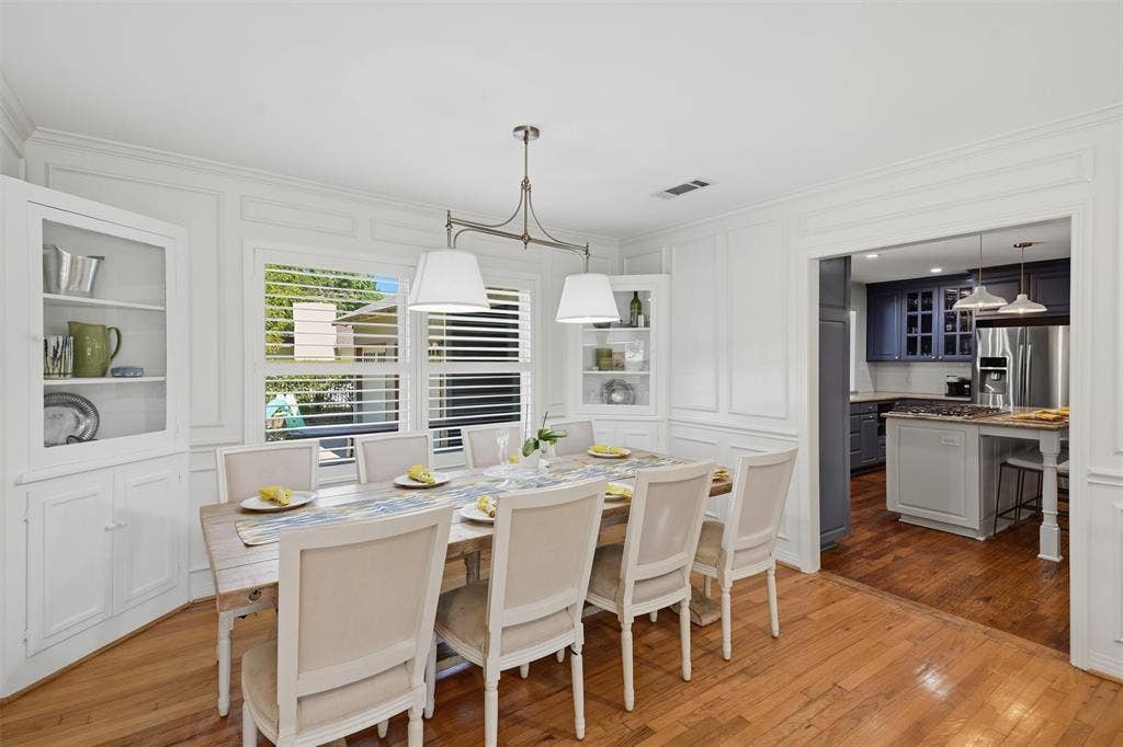 3712 Brighton Road, Fort Worth, TX 76109 Elegant formal dining room with built-in display cabinets, wall wainscoting, and seamless flow into the kitchen.