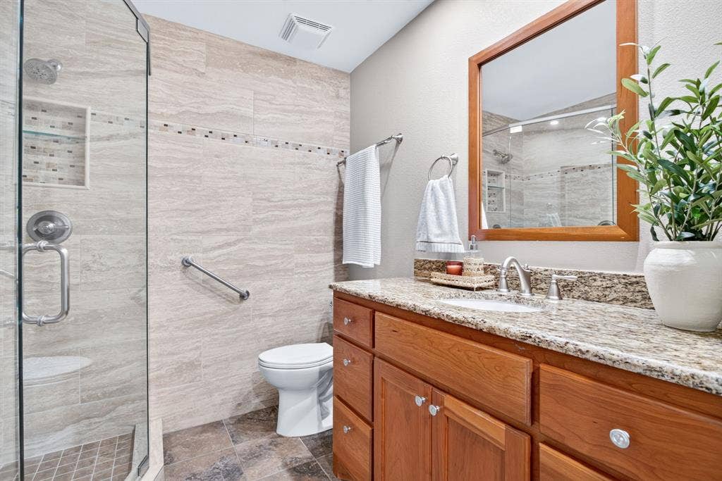 More solid wood cabinetry, custom hardware and fixtures, beautiful wood-framed mirror.