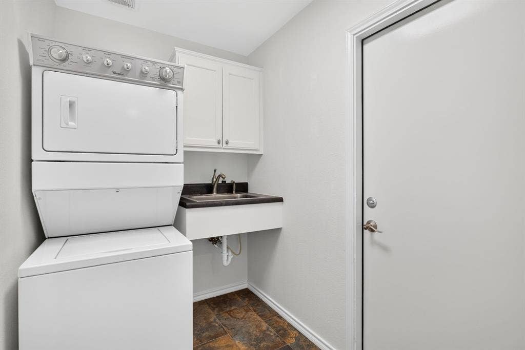 Pantry, stackable washer & dryer that conveys, plus a utility sink. GREAT use of this space!