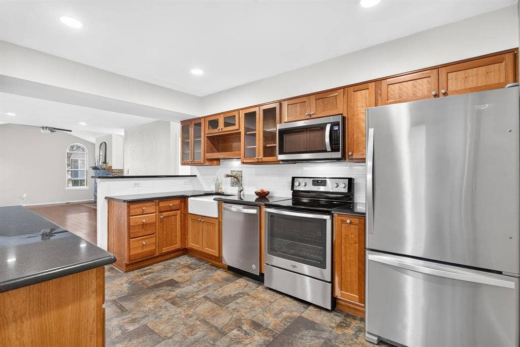 Stainless steel appliances all convey; recessed lighting throughout the space lends great light.