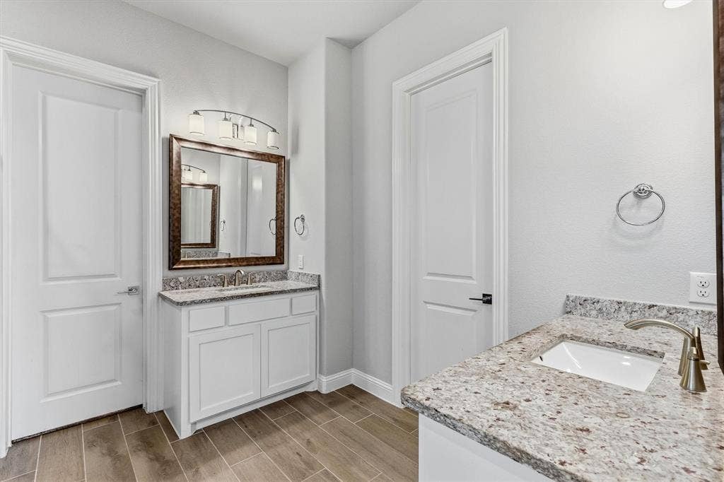Dual vanities with granite countertops